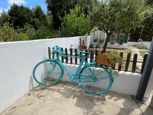 a blue bike is parked next to a fence at DEl Rey Guest House in Tomar