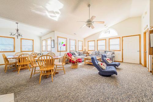 a living room with couches and a table and chairs at Clear Skies - D0363 in Sanderling