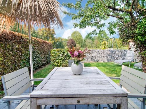 a wooden table with a vase of flowers on it at Traditional Cottage with private terrace in Amas