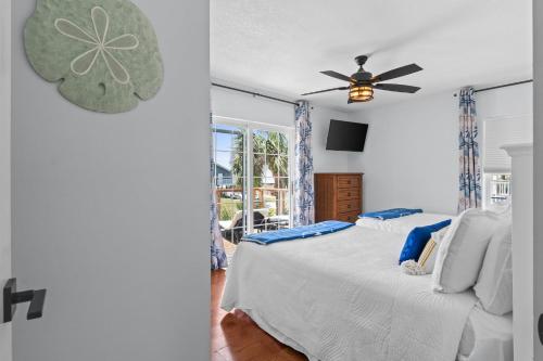 a bedroom with a bed and a ceiling fan at Stay Salty by Coastline Vacation Rentals in Cape San Blas