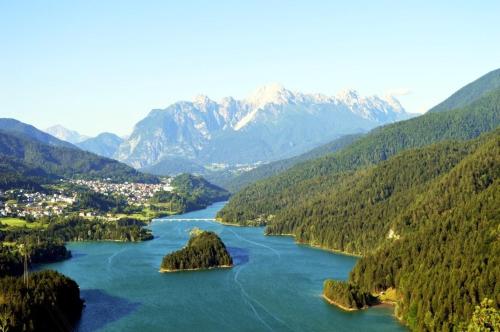 a view of a river with mountains in the background at Apartm Villa Nani west Dolomiti incantate near Cortina Winter Olympics 26 in Pieve di Cadore