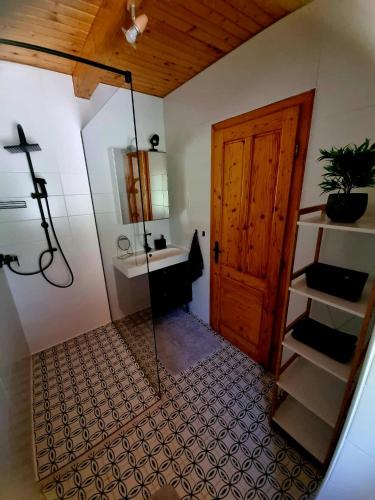 a bathroom with a shower and a glass door at Panoráma Faház Mohács in Mohács