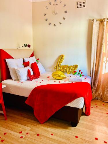 a bedroom with a bed with a clock on the wall at Executive Accommodation Bellville 1 in Bellville