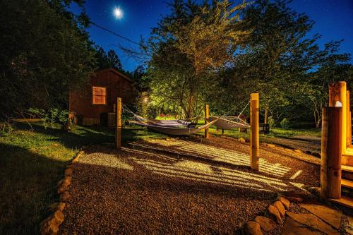 a hammock in a yard with a house and a boat at Made In The Shade by American Patriot Getaways in Shady Grove