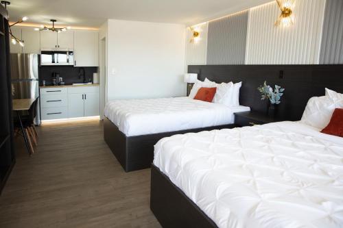 a hotel room with two beds and a kitchen at The Irish Inn Boutique Hotel in Shamrock