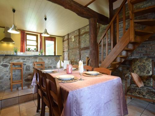 a dining room with a table and chairs and stairs at Cozy Family Stay in Durbuy in Durbuy