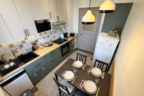 a small kitchen with a table and chairs in it at Cozy apartment in the heart of the brewery town in Schiltigheim