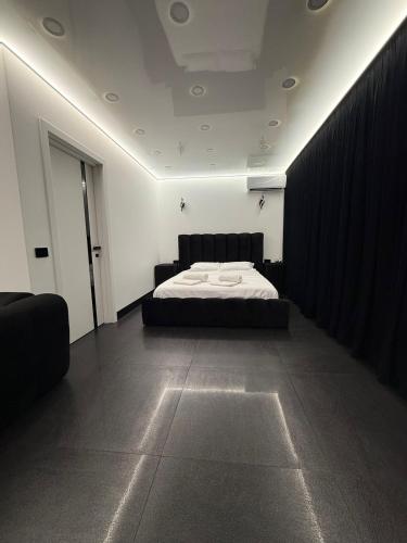 a bedroom with a bed in a room with a curtain at Jas Pipera Studio & Private Pool in Voluntari