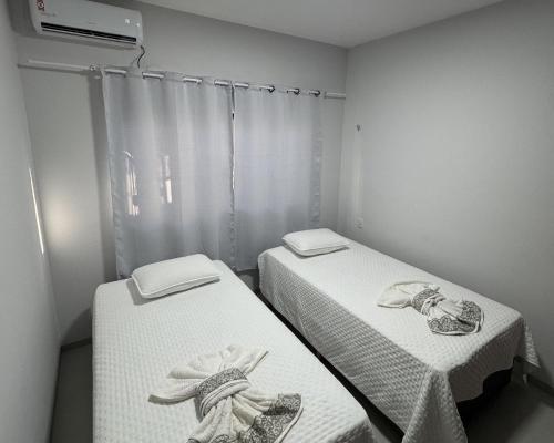 Ένα ή περισσότερα κρεβάτια σε δωμάτιο στο Sua Casa em Porto Nacional/TO. Wifi, Conforto, Localização