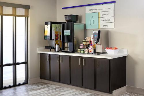 a kitchen with a counter with a coffee maker at Garner Hotel Boise Airport by IHG in Boise