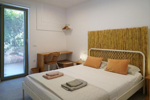 a bedroom with a bed with two towels on it at Lindas Convent Garden Home 1 in Chania Town