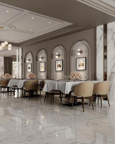 a dining room with long tables and chairs and paintings at Shirvan Grand Hotel Shamakhi in Şamaxı