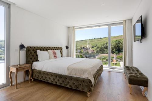 a bedroom with a large bed and a large window at GuestReady - Exquisite villa w/ Pool & Parking in Pancas