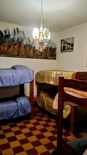 a bedroom with two bunk beds and a chandelier at El Patio Valiente in Capilla del Monte