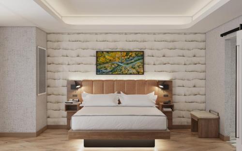 a bedroom with a bed and a painting on the wall at Hotel Indigo Gatlinburg Downtown by IHG in Gatlinburg