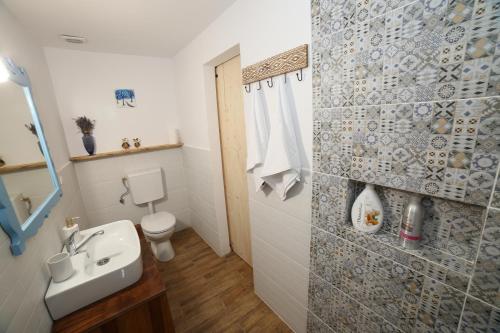 a bathroom with a sink and a toilet at Casa Ivana Jurilovca in Jurilovca