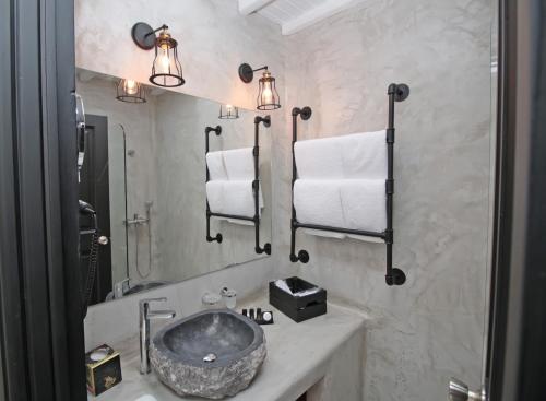 a bathroom with a sink and a mirror at Camara Studio Mykonos in Ornos