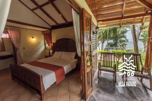 En eller flere senge i et værelse på Hotel Villa Paraiso