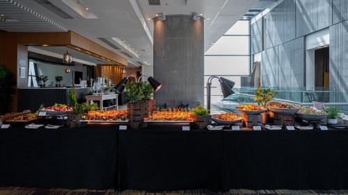 a buffet of fruits and vegetables on display in a building at The Manchester Deansgate Hotel, by IHG in Manchester