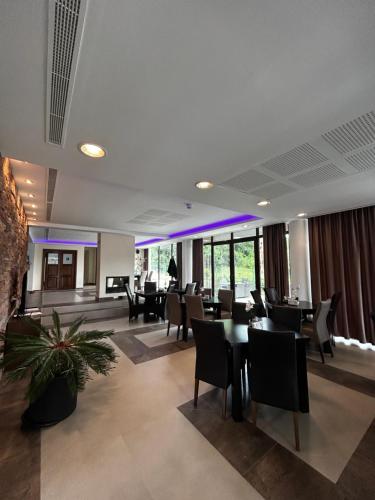 a restaurant with tables and chairs in a building at Vila Premiere Bistro-Spa in Piatra Neamţ