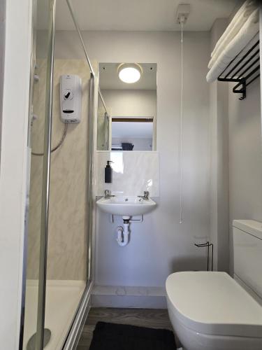 a bathroom with a sink and a shower and a toilet at PRIME Breaks in Manchester
