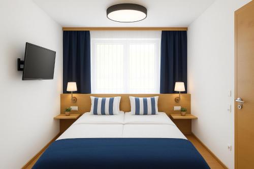 a bedroom with a bed and a tv and a window at Haus am Lift in Kleinarl
