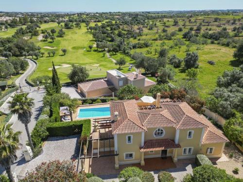 an aerial view of a house with a yard at Perfect Golf & Beach Villa for 8 people in Estômbar