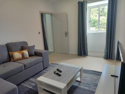 a living room with a couch and a coffee table at Calço da Figueira in Horta