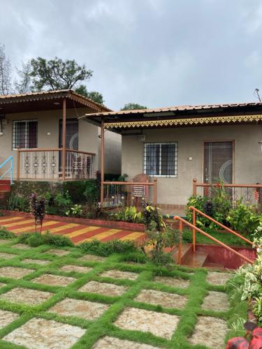 a house with a porch and a yard at Dream House in Satara
