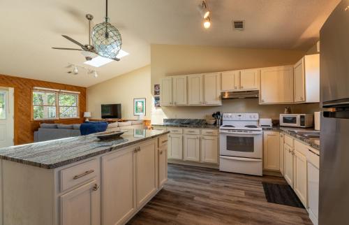 a kitchen with white cabinets and a counter top at Coker Cabana in Sanderling