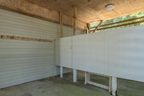 a garage with white panels on the wall at Coker Cabana in Sanderling