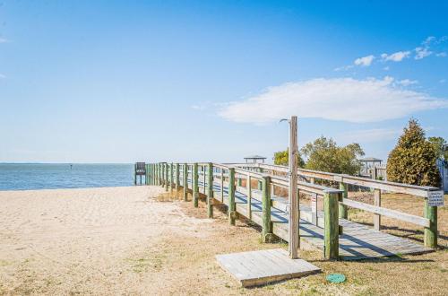 a wooden boardwalk leading to the ocean on a beach at Coker Cabana in Sanderling
