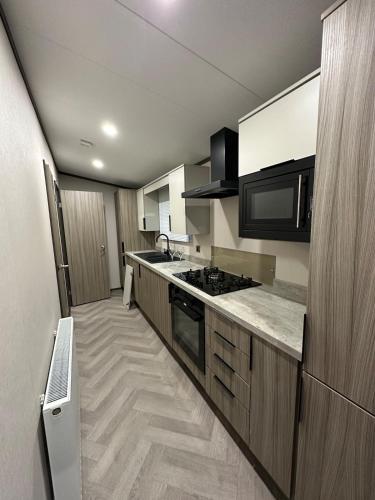 a kitchen with a sink and a stove top oven at Neptune in Parkeston