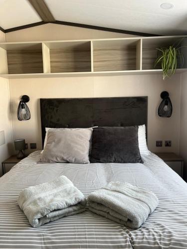 a bedroom with a bed with two towels on it at Neptune in Parkeston