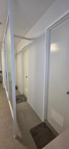 an empty hallway with white walls and doors at Cozypod Rentals in Sagcahan