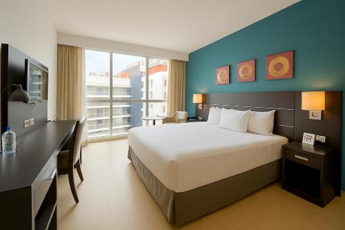 a hotel room with a large bed and a desk at Tryp by Wyndham Panama Centro in Panama City