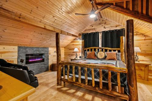 a log cabin bedroom with a bed and a fireplace at Moonlit Mountain Lodge by American Patriot Getaways in McCookville
