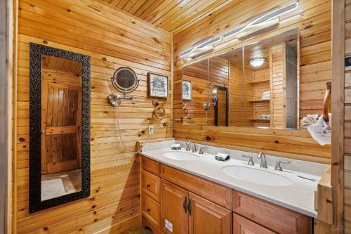 a bathroom with a sink and a mirror at Moonlit Mountain Lodge by American Patriot Getaways in McCookville