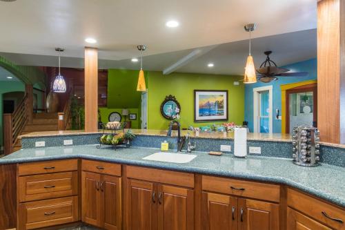 a kitchen with a sink and a counter top at Honu Hale Sunrise in Princeville