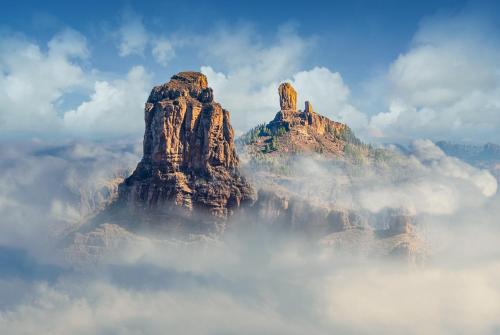a mountain rising out of the clouds at La Buhardilla del Refugio - Ideal for hikers, senderistas in Tejeda
