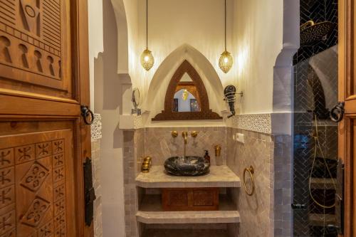 a bathroom with a sink in a room at Riad NL&S Collection in Marrakech