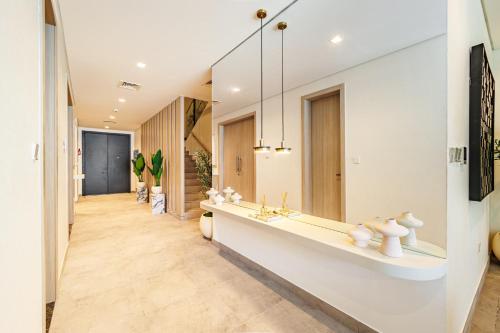 a bathroom with a sink and a mirror at Luxurious Villa on Saadiyat for Large Groups and Families in Abu Dhabi