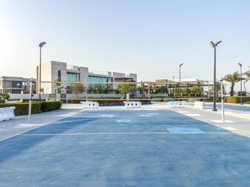 an empty parking lot with white benches in a city at Luxurious Villa on Saadiyat for Large Groups and Families in Abu Dhabi