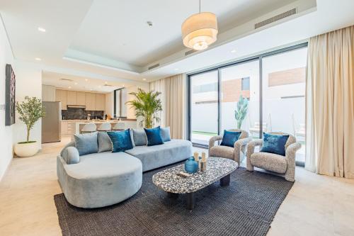 a living room with a couch and chairs and a table at Luxurious Villa on Saadiyat for Large Groups and Families in Abu Dhabi