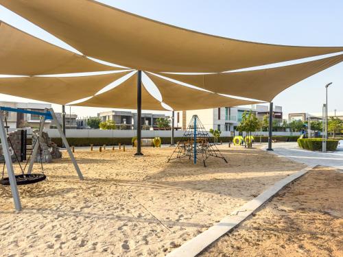 a large tan tent with chairs and a playground at Luxurious Villa on Saadiyat for Large Groups and Families in Abu Dhabi