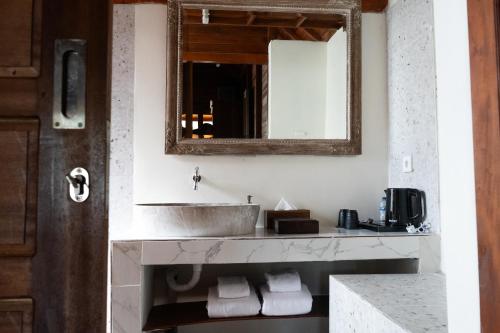 a bathroom with a sink and a mirror at Villa Budalipir - Uluwatu Bali in Uluwatu