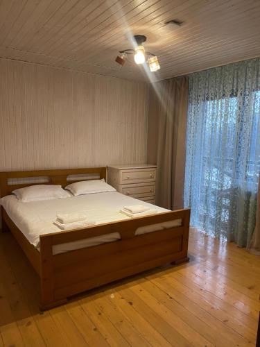 a bedroom with a large bed and a window at Tre Sorelle in Migovo