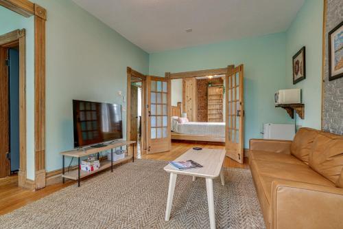a living room with a couch and a tv at 1 Mi to Xcel Energy Center Home with Yard and Garden in Saint Paul