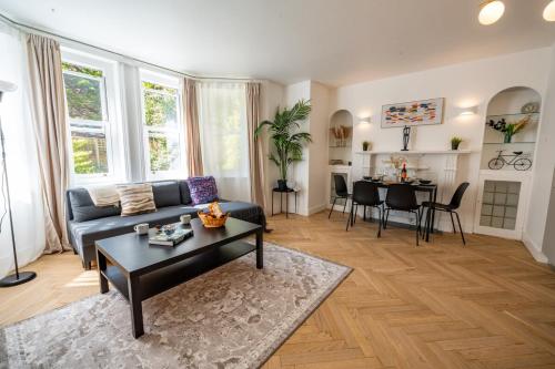 a living room with a couch and a table at Beach Getaway in Eastbourne