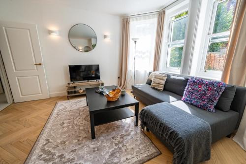 a living room with a couch and a table at Beach Getaway in Eastbourne